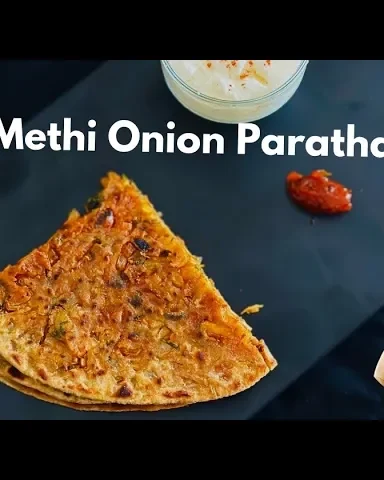 Freshly made Onion Methi Paratha with crispy golden layers, garnished with coriander, and served with yogurt