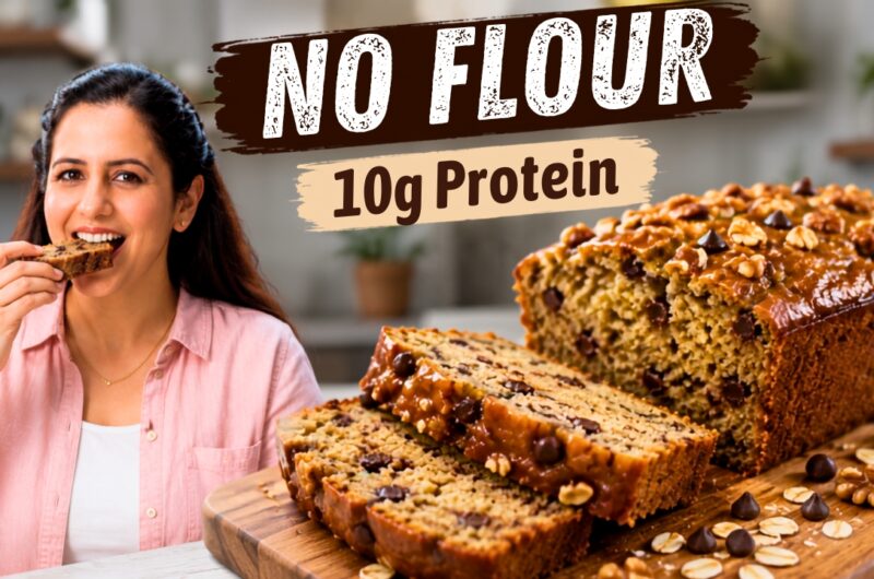 Sliced high protein banana bread loaf on parchment showing a moist crumb with walnuts and chocolate chips