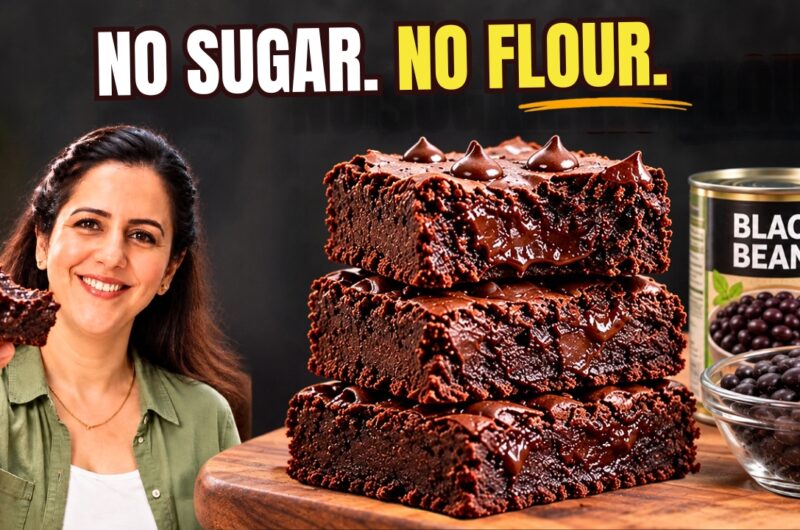 Stack of fudgy vegan black bean brownies with chocolate chips on parchment paper