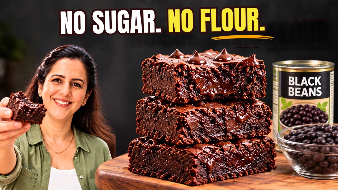 Stack of fudgy vegan black bean brownies with chocolate chips on parchment paper
