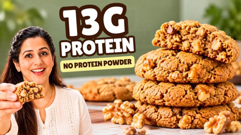 Stack of three healthy walnut cookies with the top one broken open to show a soft center and walnut pieces