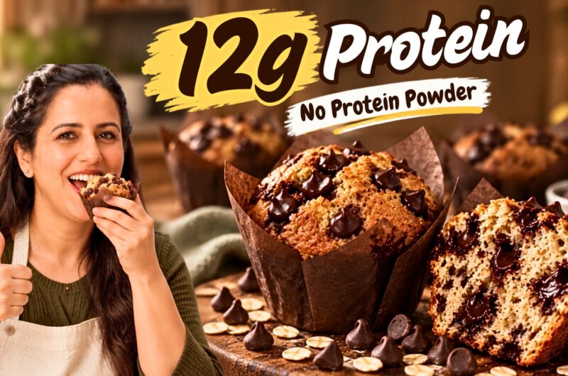 High protein chocolate chip muffin broken in half showing soft crumb and melting dark chocolate chips