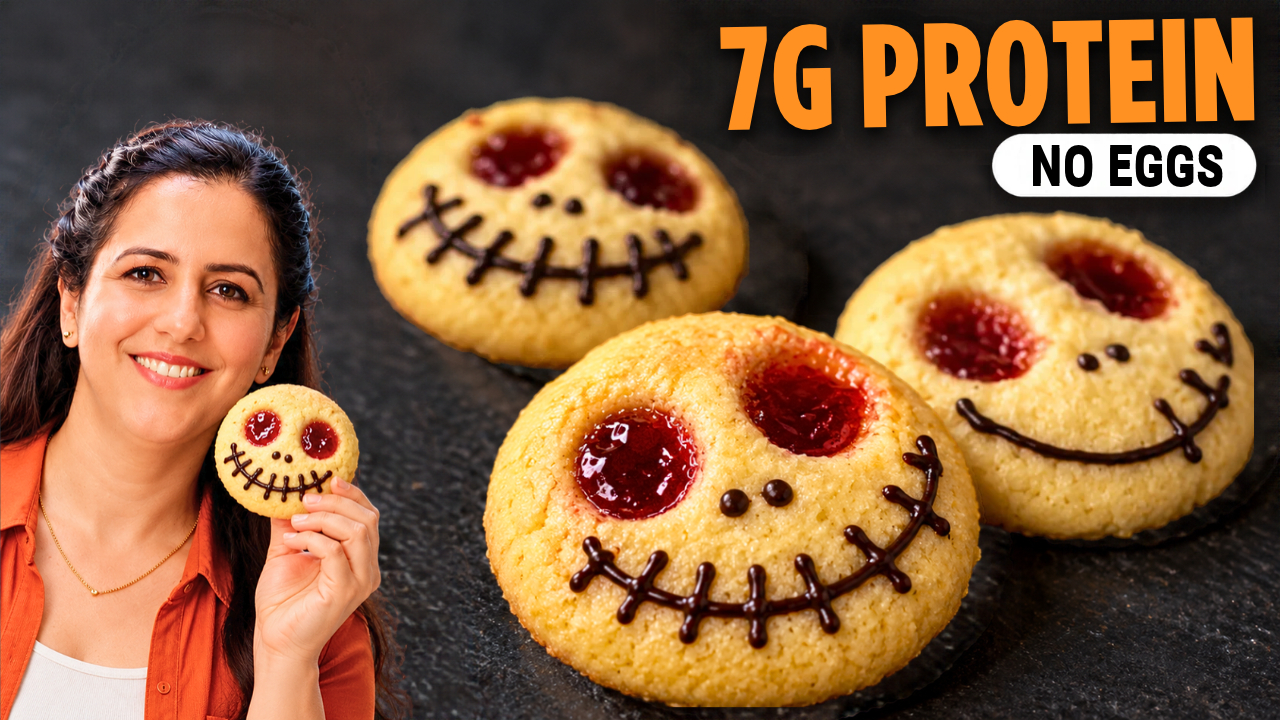 Eggless high protein Halloween cookies with strawberry jam eyes and piped chocolate faces on a dark background