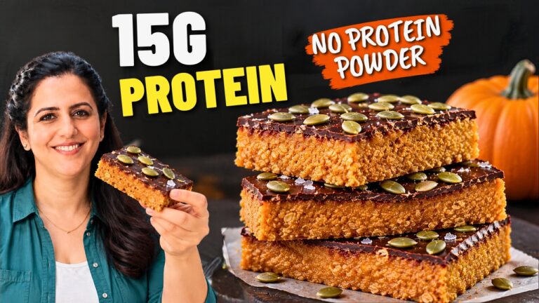 Stack of three no-bake pumpkin protein bars with a dark chocolate top and pumpkin seeds •